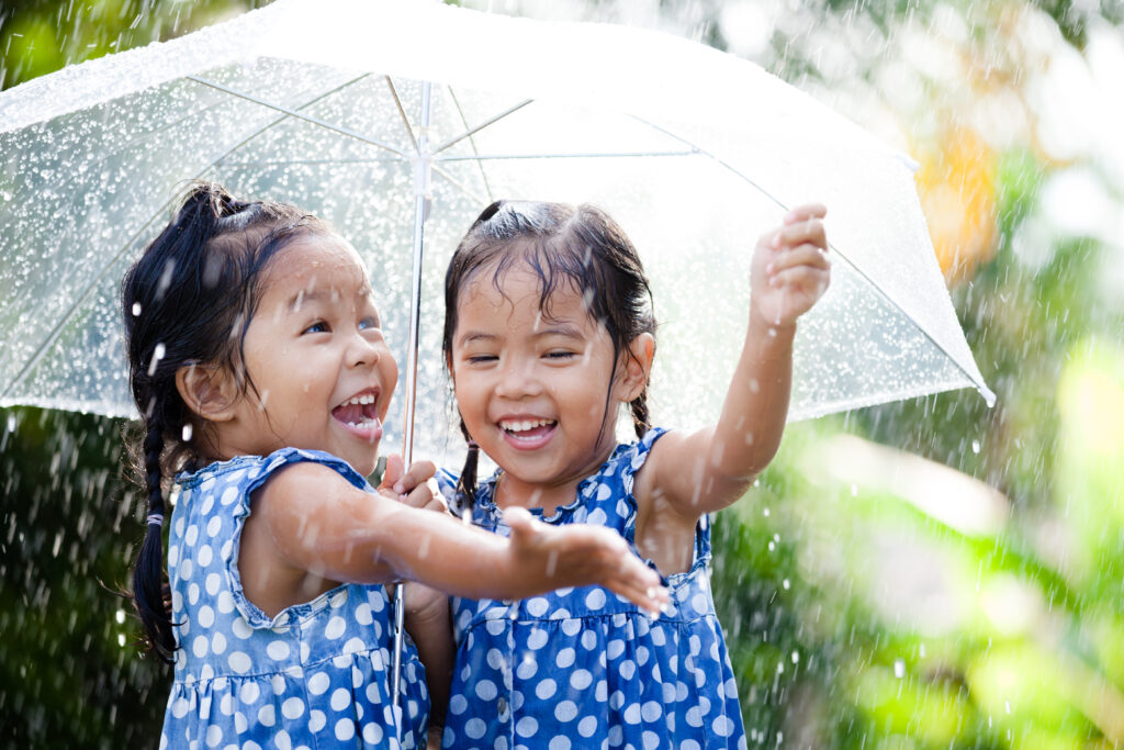 Two,Happy,Asian,Little,Girls,With,Umbrella,Having,Fun,To,Kids,Therapy